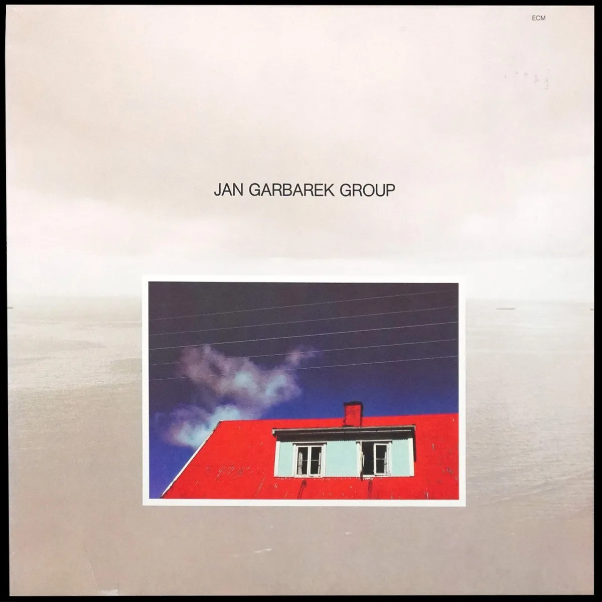 LP Jan Garbarek Group — Photo With Blue Sky, White Cloud, Wires, Windows And A Red Roof фото